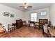 Spacious bedroom with hardwood floors, ceiling fan, and multiple furniture pieces at 1830 Light Brigade Dr, Matthews, NC 28105