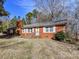 Classic brick home with white trimmed windows and a chimney on the left at 1830 Light Brigade Dr, Matthews, NC 28105