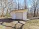 White garage with a roll up door provides extra storage and protection from the weather at 1830 Light Brigade Dr, Matthews, NC 28105