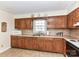 Functional kitchen with wooden cabinets, light countertops, and tile flooring at 1830 Light Brigade Dr, Matthews, NC 28105