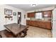 Inviting kitchen with wooden cabinetry, a dining table, and a tiled floor at 1830 Light Brigade Dr, Matthews, NC 28105