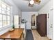 Bright laundry room featuring tile floors, wooden cabinets, and a large window for natural light at 1830 Light Brigade Dr, Matthews, NC 28105