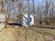 White storage shed with side entry door, perfect for storing lawn equipment and other outdoor items at 1830 Light Brigade Dr, Matthews, NC 28105