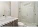 Modern bathroom with a glass shower and white tile at 1906 Lakedell Dr, Charlotte, NC 28215