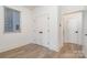 Light-filled bedroom featuring hardwood floors and double doors at 1906 Lakedell Dr, Charlotte, NC 28215