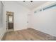 Well-lit bedroom with hardwood floors and access to bathroom at 1906 Lakedell Dr, Charlotte, NC 28215