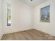 Bedroom with hardwood floors and large window with blinds at 1906 Lakedell Dr, Charlotte, NC 28215