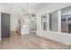 Open dining area with hardwood floors and modern chandelier at 1906 Lakedell Dr, Charlotte, NC 28215