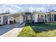 Modern home with gray and white exterior, carport, and landscaped lawn at 1906 Lakedell Dr, Charlotte, NC 28215