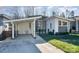 Modern two-story home with gray and white siding, carport, and landscaped lawn at 1906 Lakedell Dr, Charlotte, NC 28215