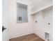 Laundry room with white shelving and wood flooring at 1906 Lakedell Dr, Charlotte, NC 28215