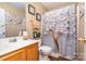 Clean bathroom with shower, toilet, and wood vanity at 2219 Kirkgate Ln, Charlotte, NC 28215