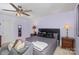 Spacious bedroom with a large bed, ceiling fan, and ample natural light at 2219 Kirkgate Ln, Charlotte, NC 28215