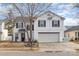 Two-story house with attached garage and landscaping at 2219 Kirkgate Ln, Charlotte, NC 28215