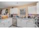 Modern kitchen with white cabinets, gray counters, and stainless steel appliances at 2219 Kirkgate Ln, Charlotte, NC 28215