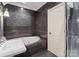 Elegant bathroom with soaking tub, dark tile, and frameless shower at 2310 La Maison Dr, Charlotte, NC 28226