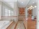 Elegant bathroom with soaking tub, double vanity, and marble accents at 2310 La Maison Dr, Charlotte, NC 28226