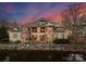 Brick and stone luxury home with water views at sunset at 2310 La Maison Dr, Charlotte, NC 28226