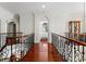 Upper hallway with hardwood floors, leading to bedroom at 2310 La Maison Dr, Charlotte, NC 28226