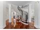 Grand curved staircase with ornate railing in a spacious foyer at 2310 La Maison Dr, Charlotte, NC 28226