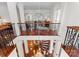 Open upper hallway with hardwood floors and ornate railing at 2310 La Maison Dr, Charlotte, NC 28226