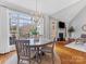 Bright dining room with hardwood floors and chandelier at 353 Killian Ct, Matthews, NC 28104