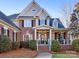 Two-story home with brick and siding, welcoming porch at 353 Killian Ct, Matthews, NC 28104