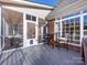 Screened porch with table and chairs, offering a peaceful outdoor space at 353 Killian Ct, Matthews, NC 28104