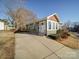 Updated home with a new driveway, landscaping, and gray siding at 535 Brooklyn Ave, Cramerton, NC 28032