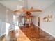 Sunlit living room with hardwood floors, exposed beams, and ceiling fan at 535 Brooklyn Ave, Cramerton, NC 28032