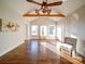 Living room with hardwood floors, exposed beams, and a ceiling fan at 535 Brooklyn Ave, Cramerton, NC 28032