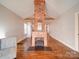 Living room with brick fireplace and hardwood floors at 535 Brooklyn Ave, Cramerton, NC 28032