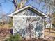 Small gray shed with a weathered wooden door at 535 Brooklyn Ave, Cramerton, NC 28032