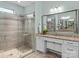 Spa-like bathroom featuring a walk-in shower and granite vanity at 7145 Hanging Rock Ct, Denver, NC 28037