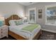 Bright bedroom with a comfortable bed and plenty of natural light at 7145 Hanging Rock Ct, Denver, NC 28037