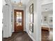 Bright entryway with hardwood floors and a view into the living room at 7145 Hanging Rock Ct, Denver, NC 28037