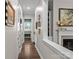 Inviting hallway with hardwood floors and tasteful artwork at 7145 Hanging Rock Ct, Denver, NC 28037