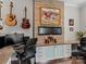 Home office features a wood accent wall, desk, and fireplace at 7145 Hanging Rock Ct, Denver, NC 28037