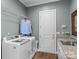 Bright laundry room with washer, dryer, and additional shelving at 7145 Hanging Rock Ct, Denver, NC 28037