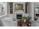 Cozy living room with fireplace and built-in shelving at 7145 Hanging Rock Ct, Denver, NC 28037