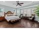 Relaxing main bedroom with hardwood floors and ceiling fan at 7145 Hanging Rock Ct, Denver, NC 28037