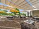 Outdoor patio seating area with yellow umbrellas and shade structure at 7145 Hanging Rock Ct, Denver, NC 28037