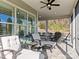 Relaxing screened porch with seating and ceiling fan at 7145 Hanging Rock Ct, Denver, NC 28037