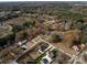 Aerial view of a residential area, highlighting two houses with a pool in a quiet setting at 719 Greenbriar Dr, Matthews, NC 28104