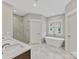 Elegant bathroom with soaking tub, double vanity, and walk-in shower at 719 Greenbriar Dr, Matthews, NC 28104