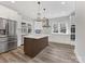 Modern kitchen with white cabinets, stainless steel appliances, and an island at 719 Greenbriar Dr, Matthews, NC 28104