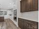 Kitchen boasts dark brown cabinets and stainless steel appliances at 719 Greenbriar Dr, Matthews, NC 28104