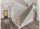 Elegant staircase with metal balusters leading to upper level at 719 Greenbriar Dr, Matthews, NC 28104