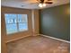 Well-lit bedroom featuring neutral walls and carpet at 104 Lassiter Ct, Mount Holly, NC 28120