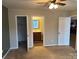 Bright bedroom with neutral carpeting, an ensuite bathroom and walk-in closet at 104 Lassiter Ct, Mount Holly, NC 28120